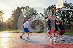 Group Of Young Friends Playing Basketball Match