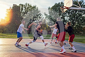 Group Of Young Friends Playing Basketball Match