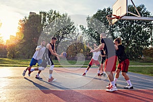 Group Of Young Friends Playing Basketball Match