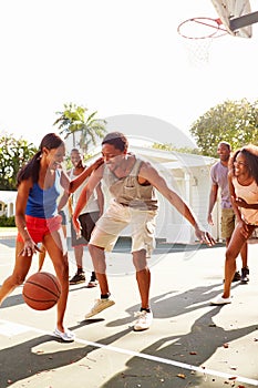 Group Of Young Friends Playing Basketball Match