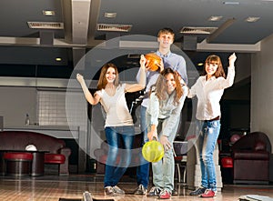 Group of young friends playing bowling