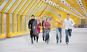 Group of young friends runs on footbridge