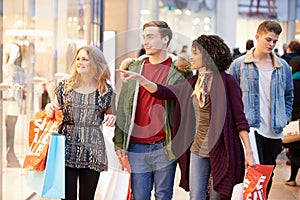 Group Of Young Friends Shopping In Mall Together