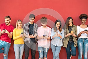Group young friends using mobile smartphone outdoor - Millennial generation having fun with new trends social media apps