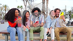 Group of young friends using the smartphone to browse on internet, take selfies, share on the social media, and order a