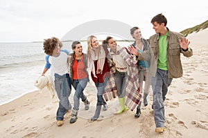 Group Of Young Friends Walking Shoreline