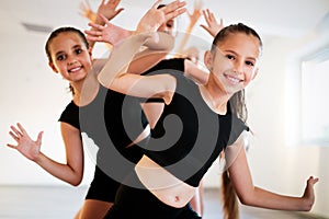 Group of young girls practicing and exercising modern ballet dance.