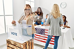 Group of young girls voting at democracy referendum approving doing positive gesture with hand, thumbs up smiling and happy for