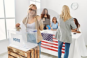 Group of young girls voting at democracy referendum doing happy thumbs up gesture with hand