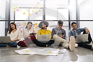 Group of young happy Asian creative business people or hipster student using electronic devices tablet and laptop connection