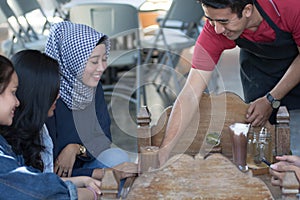 Group of young happy friend receives food and drink from waiters and server at cafe and restaurant