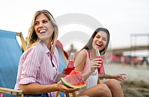 Group of young friends having fun at the beach on vacation party. People happiness concept