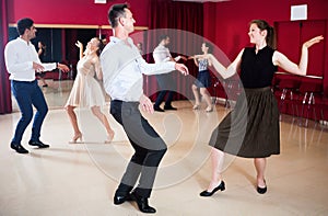 Group of young happy people dancing twist