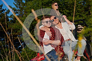 group young happy people enjoying beautiful sunny day while driving a off road buggy car