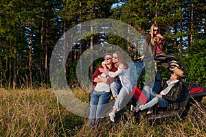 group young happy people enjoying beautiful sunny day while driving a off road buggy car