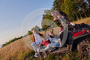 group young happy people enjoying beautiful sunny day while driving a off road buggy car