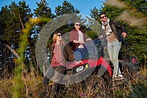 group young happy people enjoying beautiful sunny day while driving a off road buggy car