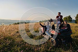 group young happy people enjoying beautiful sunny day while driving a off road buggy car