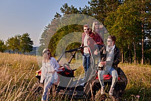 group young happy people enjoying beautiful sunny day while driving a off road buggy car