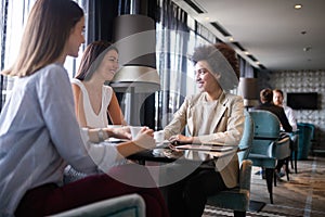Group of young happy women drinking coffee