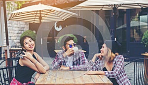 Group of young hipster sitting in a cafe,Young cheerful friends having fun while take time together, Holiday freedom enjoy