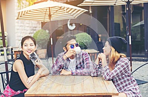 Group of young hipster sitting in a cafe,Young cheerful friends having fun while take time together, Holiday freedom enjoy