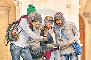 Group of young hipster tourist friend having fun with smartphone photo