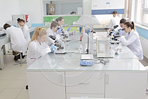 Group of young Laboratory scientists working at lab with test tu