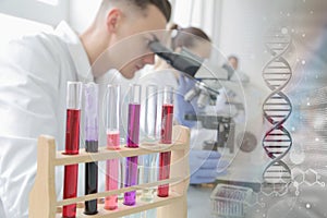 Group of young Laboratory scientists working at lab with test tubes and microscope, test or research in clinical laboratory.