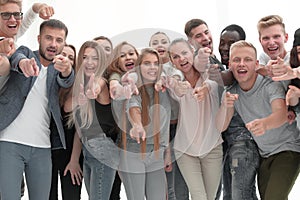 Group of young like-minded people pointing at you