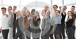 Group of young like-minded people pointing at you