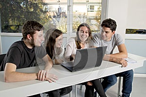 Group of young male and female teenager university students at school sitting on classroom learning and working on project togethe