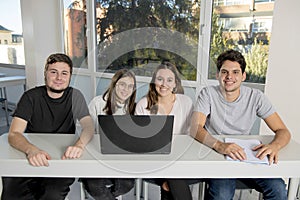 Group of young male and female teenager university students at school sitting on classroom learning and working on project togethe