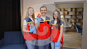 A group of young medical people in uniform stand in the middle of the classroom and smile after a first aid lesson