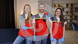 A group of young medical people in uniform stand in the middle of the classroom and smile after a first aid lesson