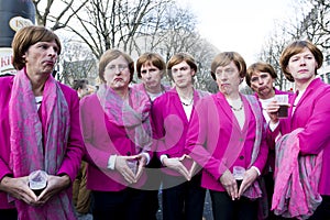 Group of young men posing as Angela Merkel on street carnival in Dusseldorf