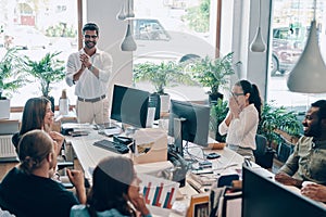 Group of young modern people in smart casual wear