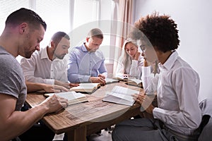 Group Of Young Multiethnic People Reading Bible photo