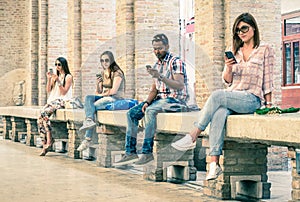 Group of young multiracial friends using smartphone