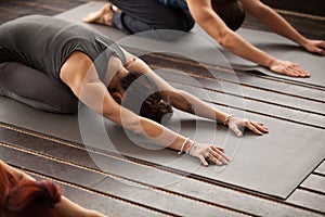 Group of young people in Balasana pose