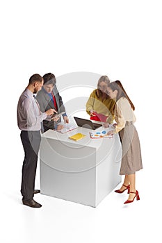 Group of young people, businessmen, office workers in business style clothes isolated over white background. Teamwork