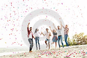 Group of young people celebrating at the beach