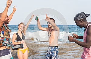group of young people celebrating with music at the beach