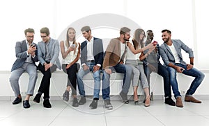 Group of young people communicate in the waiting room.