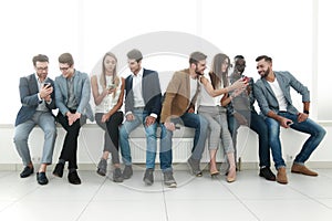 Group of young people communicate in the waiting room.