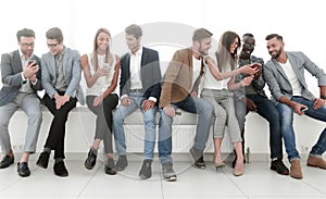 Group of young people communicate in the waiting room.