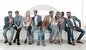 Group of young people communicate in the waiting room.