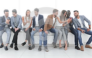 Group of young people communicate in the waiting room.