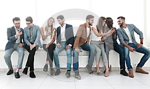 Group of young people communicate in the waiting room.