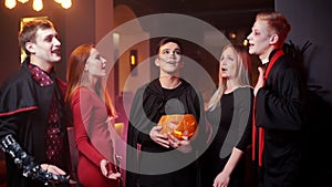 Group of young people in costumes celebrate Halloween party for sing a song